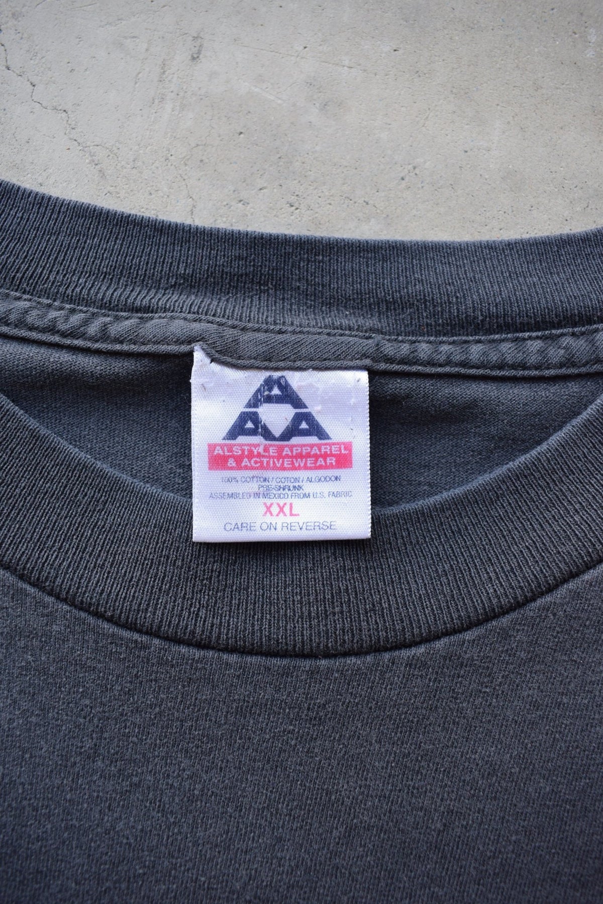 Bad Bones 'Rock The World' Faded-Black Graphic Tee — 1990s (XXL) - Retrospective Store