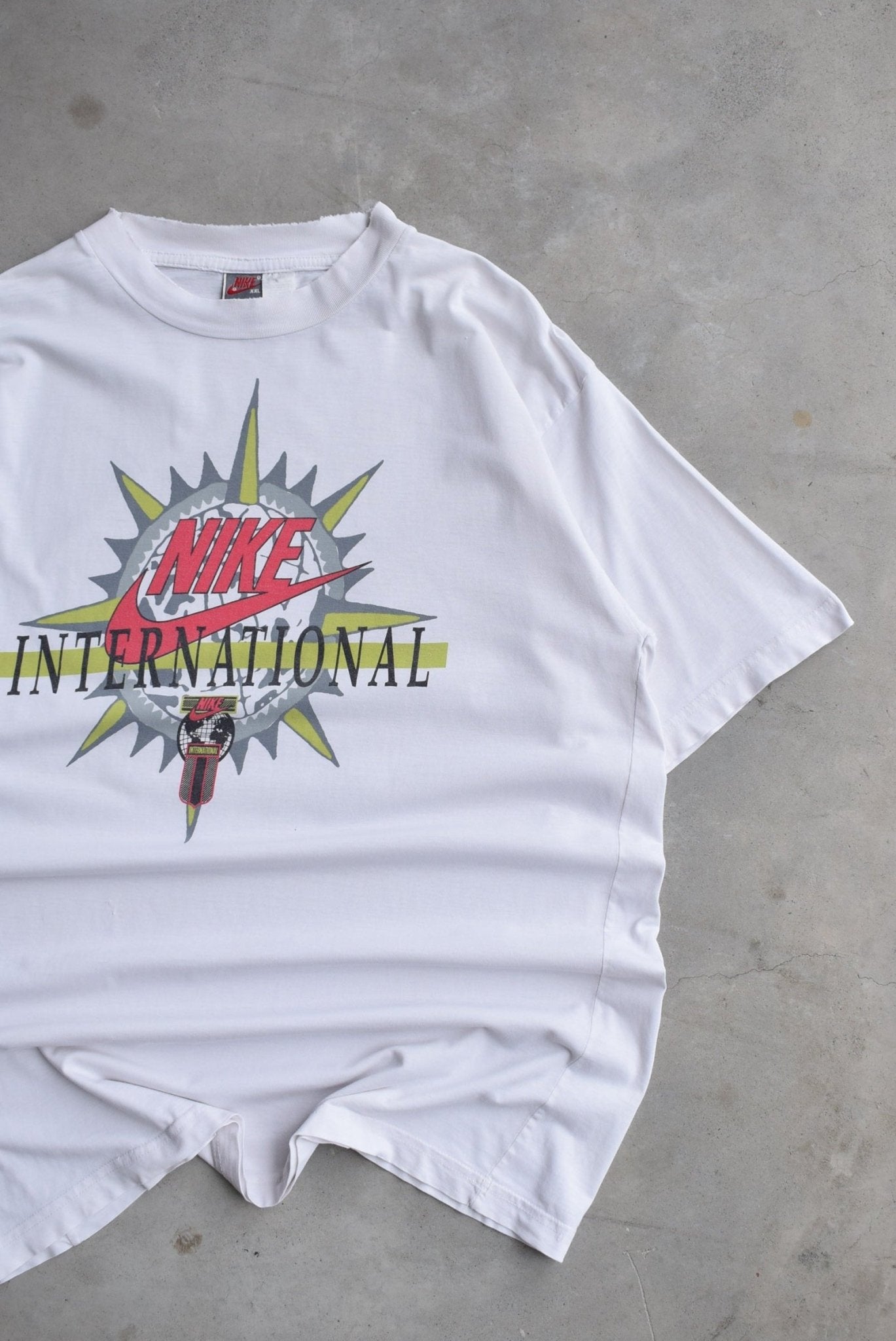 Nike International White Graphic Tee — 1990s (XL) - Retrospective Store
