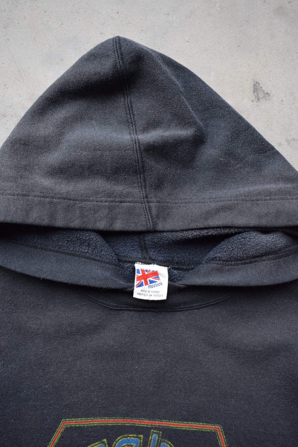 Reebok Faded-Black Spellout Hoodie — 1990s (M/L) - Retrospective Store