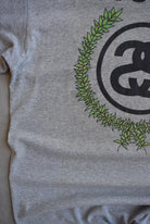 Stussy Grey Spellout Graphic Tee — 2000s (L) - Retrospective Store