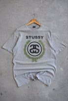 Stussy Grey Spellout Graphic Tee — 2000s (L) - Retrospective Store