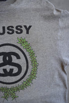 Stussy Grey Spellout Graphic Tee — 2000s (L) - Retrospective Store